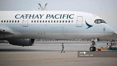 (FILES) This photo taken on 13 December 2023 shows a Cathay Pacific aircraft parked at Hong Kong International Airport.