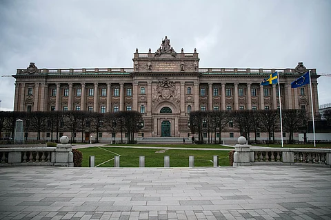 (FILES) The Swedish and EU flags fly in front of the Swedish Parliament on April 16, 2020 in Stockholm. – Two Afghans linked to the Islamic State group were arrested in Germany on March 19, 2024 on suspicion of planning an attack around Sweden’s parliament in retaliation for Koran burnings, prosecutors said.