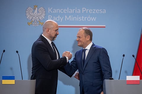 Ukraine's Prime Minister Denys Shmyhal (L) and Polish Prime Minister Donald Tusk shake hands after a joint press conference after bilateral talks to resolve a conflict over farm imports in Warsaw on 28 March 2024. Polish farmers have been blocking border crossings with Ukraine since last month to protest at what they say is unfair competition for goods from the war-torn country.