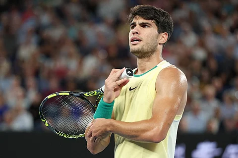 (FILES) Spain's Carlos Alcaraz reacts after a point against Germany's Alexander Zverev during their men's singles quarter-final match on day 11 of the Australian Open tennis tournament in Melbourne on 24 January 2024. Alcaraz announced on 9 April 2024, forfeiting his participation in the Monte Carlo ATP Masters Series Tournament, he said on social media.