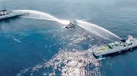 Handout/Philippine Coast Guard
Outnumbered, outsized A Philippine Coast Guard vessel gets the ‘Beijing treatment’ — hit on both sides by powerful ‘jetstream’ water cannons by two of its counterparts from China on Tuesday, while resupplying Filipino fishermen at Scarborough Shoal. And the Chinese had the temerity to cry foul?