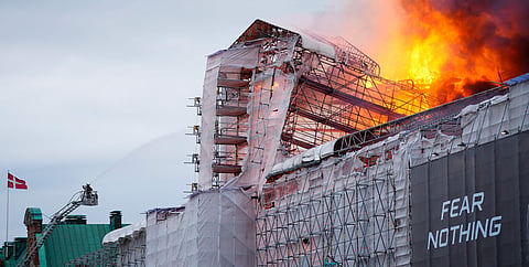 This photograph shows flames engulfing the Copenhagen’s Stock Exchange building, in Copenhagen, on Tuesday