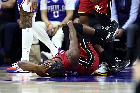 JIMMY Butler of the Miami Heat grimaces in pain after hurting his right knee following a collision with Kelly Oubre Jr. of the Philadelphia 76ers in their NBA play-in encounter.