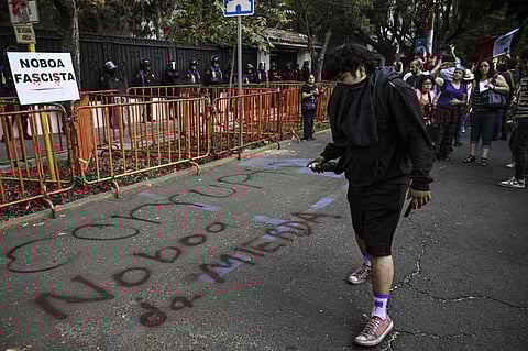 A young man paints a graffiti against Ecuadorian President Daniel Noboa during a protest outside the Ecuadorian embassy in Mexico City on 6 April 2024, following the severance of diplomatic relations between the two countries. Ecuadorian authorities stormed the Mexican embassy in Quito on 5 April to arrest former vice president Jorge Glas, who had been granted political asylum there, prompting Mexico to sever diplomatic ties after the "violation of international law".