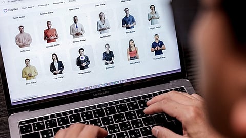 (FILES) This photo illustration taken on 22 December 2023 shows a user on an AI video generator website on a laptop computer.