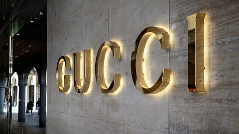(FILES) Italian fashion company Gucci's sign is pictured outside a flag ship store in Lugano.