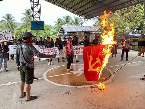 (FILE PHOTO) Burning with resolve Rallyists torch a communist flag, standing united against insurgency and embracing freedom during a demonstration coinciding with the New People’s Army’s founding anniversary on 29 March. Simultaneous rallies in Bukidnon, Davao del Norte, and Davao City denounced the NPA’s 55 years of unjust killings, destruction of properties, extortion, and other lawless activities disturbing the peace in communities.