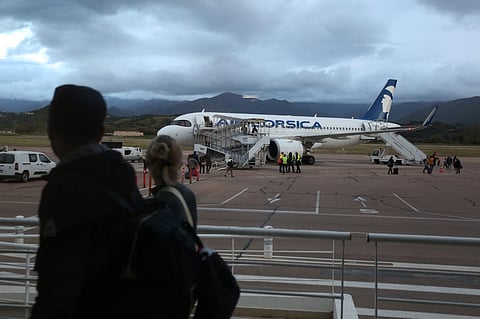 Travellers walk to an Air Corsica plane at the Napoleon Bonaparte airport in Ajaccio, on the French Mediterranean island of Corsica, on 22 April 2024. "Serious failures" in luggage and passenger screening at Ajaccio airport have been reported since "December 2022", the prefect of Corsica indicated on 23 April 2024, as the tourist season approaches and the France's Vigipirate security alert have been raised to its highest level.