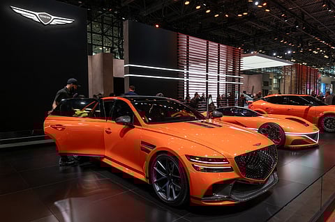 NEW YORK, NEW YORK - MARCH 27: People walk by Genesis's new electric vehicles, including the Neolun Concept and the GV60 Magma Concept, at the New York International Auto Show on 27 March 2024 in New York City. The annual show, which opens to the public on 29th March, is one of the largest auto shows in the world and reveals numerous new car models for both the public and the media. This year's show includes an emphasis on new electric and hybrid models.