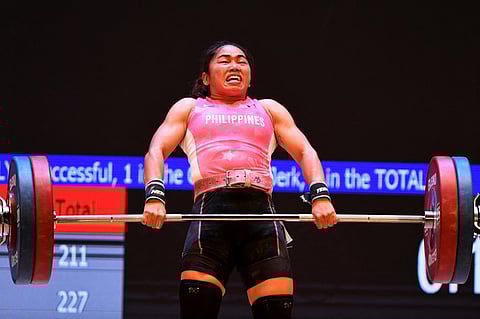 (FILES) Philippines' Hidilyn Diaz competes in the women's 55kg weightlifting event during the 31st Southeast Asian Games (SEA Games) in Hanoi on 20 May 2022.
Tang Chhin Sothy / AFP