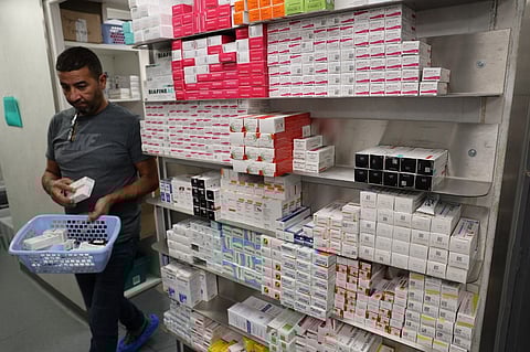 (FILES) A pharmacist works in the the Delpech pharmacy in Paris, on 28 September 2023. Amoxicillin, corticoids and now flecaine: faced with supply difficulties, a Paris pharmacy is now making its own capsules of this treatment for cardiac arrhythmias, a very common drug that has also been unavailable for months.