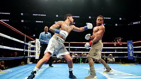 Ryan Garcia (white trunks) punches Devin Haney (gray trunks) during their WBC Super Lightweight title bout at Barclays Center on April 20, 2024 in New York City.