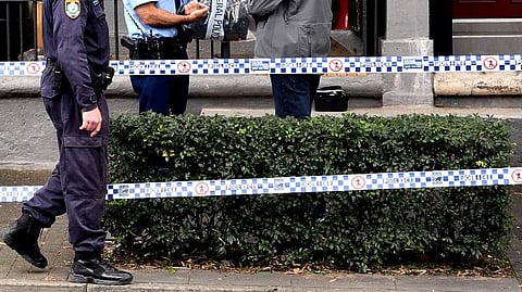 (FILES) Police stand guard outside a house in the inner Sydney suburb of Surry Hills on 30 July 2017, after a raid in a major joint counter-terrorism operation.