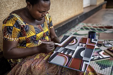 A genocide survivor belonging to the Kakira Imigongo Cooperative paint pieces of traditional Imigongo cow dung art in Kirehe on 4 April 2024. A 200-year-old Tutsi art form made with cow dung, Rwanda's Imigongo painting tradition has experienced a revival in the Great Lakes nation three decades after the 1994 genocide, becoming a symbol of culture and unity. Known for its raised black and white patterns, imigongo is widely believed to have been invented by a Tutsi prince in the 19th century.