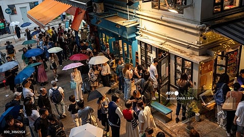 Visitors pay tribute to the independent bookstore 'Mount Zero' on its last day of business in Hong Kong on 31 March 2024.