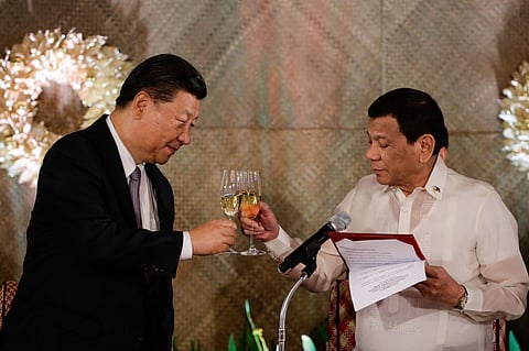 (FILES) Chinese President Xi Jinping (left) and then-President Rodrigo Duterte toast good relations between Beijing and Manila during the former's visit to Malacanang Palace in 2018.