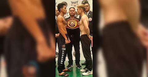 Regie Suganob (left) and Japanese opponent Kai Ishizawa size each other up as they brace for a tough bout Tuesday in Tagbilaran, Bohol.