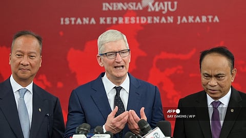 Apple CEO Tim Cook (C) speaks, alongside Indonesian Minister of Communication and Information Budi Arie Setiadi (R) and Indonesian Minister of Industry Agus Gumiwang Kartasasmita (L), during a press conference after meeting with Indonesia's President Joko Widodo at the Merdeka Palace in Jakarta in April 2024.