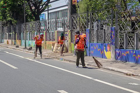 Amid the scorching Monday heat, street sweepers continue to do their job along Pasay Road but not without protective gear such as long-sleeved vests, caps and face covering.