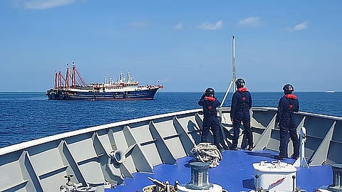(FILES) Philippine Coast Guard crew members aboard the BRP Cabra monitor a Chinese vessel anchored at Sabina Shoal, a West Philippine Sea outcrop located about 135 kilometers west of Palawan. China’s ‘aggressive’ actions in the WPS have earned condemnation from the Philippines and such countries as the United States, Japan, and Australia.