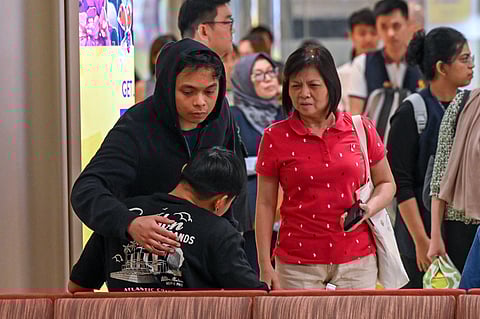 Passengers of Singapore Airlines flight SQ321 from London to Singapore, comfort each other upon arrival at Changi Airport in Singapore. They described a terrifying scene aboard the aircraft after hitting severe turbulence, triggering an emergency landing in Bangkok.