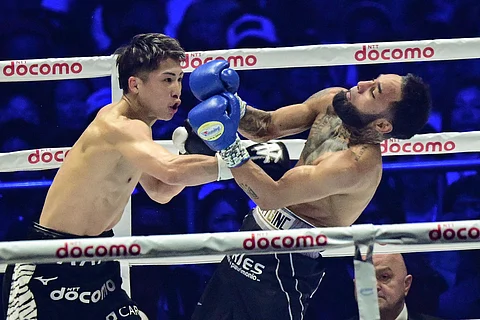 NAOYA Inoue (left) recovers from an early mishap to knock down Luis Nery in the sixth round of their super-bantamweight world title fight late Monday at the Tokyo Dome in Japan.