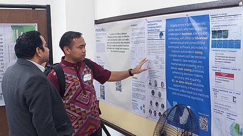 Dr. Renier Mendoza presenting UPD-CS IM’s value proposition poster to a research adoptor
