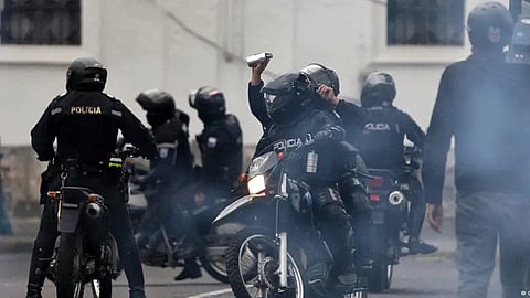 Riot police disperse demonstrators with tear gas during indigenous-led protests in Quito