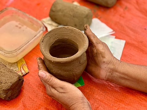A participant making a salt pot.
