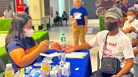 An elderly patient avails of free medical services at SM City Marilao's SM Foundation medical mission.
