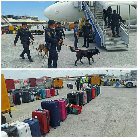 Personnel of the Philippine National Police Aviation Security Group conduct a bomb inspection on PAL flight PR412, bound for Kansai, Japan, at NAIA 1 on Wednesday. A bomb threat made via phone call affected 200 passengers.