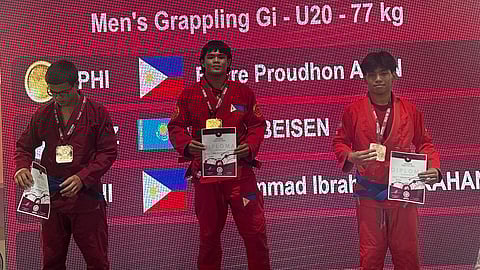 FIERRE Afan (center) steps on the medal podium after clinching two gold medals in the 2024 United World Wrestling Asian Grappling Championship.