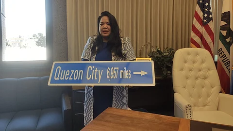Daly City Mayor Juslyn Manalo stood proudly holding a large sign that read, ‘Quezon City 6,957 miles,’ symbolizing the distance between the two sister cities.