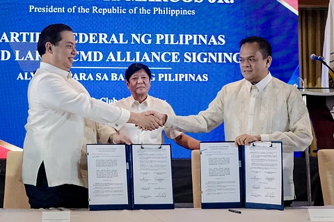 One in purpose President Ferdinand ‘Bongbong’ Marcos Jr. stands between Speaker Martin Romualdez of the Lakas-CMD party and South Cotabato Gov. Reynaldo Tamayo Jr., president of Partido Federal ng Pilipinas after the signing of an agreement to cement the alliance of both political parties.