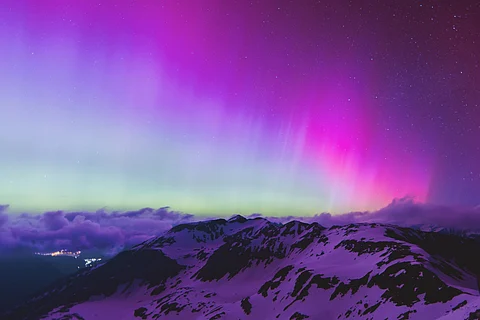 Northern lights or aurora borealis illuminate the night sky over Fusch an der Großglocknerstraße, near Zell am See, during a geomagnetic storm on May 11, 2024. – The planet is experiencing its first “extreme” geomagnetic storm since 2003, a US agency said on Mai 10, 2024.