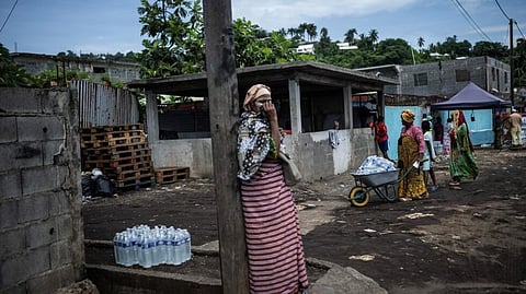 Residents collect packs of bottled drinking water from a distribution point in Mamoudzou on the French Indian Ocean island of Mayotte, on February 19, 2024.