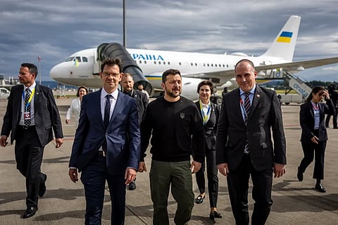 Ukraine's Zelenskyy (centre) is welcomed by Switzerland's ambassador to Ukraine Felix Baumann (left) and other officials as he arrives at the Zurich airport ahead of the Ukraine summit