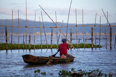 FISHERMAN in Laguna de Bay. Around 8 million Filipinos are directly and indirectly dependent on marine and coastal resources.