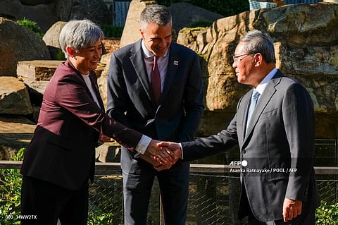 Australia's Foreign Minister Penny Wong (L) shakes hands with China's Premier Li Qiang (R) as South Australian Premier Peter Malinauskas (C) looks on during Li's visit to the Adelaide Zoo in Adelaide on June 16, 2024.