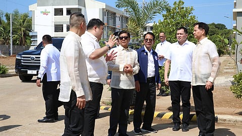 (FILES) President Ferdinand Marcos Jr. leads the Ceremonial Turnover of the NHA Balanga City Low-Rise Housing Project at Barangay Tenejero Balanga City Bataan. With him are Bataan Governor Jose Enrique Garcia III, DHSUD Secretary Jose Rizalino Acuzar, NHA General Manager Joeben Tai, Bataan 2nd District Representative Albert Raymond Garcia and Balanga City Mayor Francis Anthony Garcia.