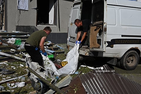 Communal workers evacuate the body of a local resident killed in an aerial bomb in the centre of Kharkiv, on June 22, 2024, amid the Russian invasion of Ukraine.