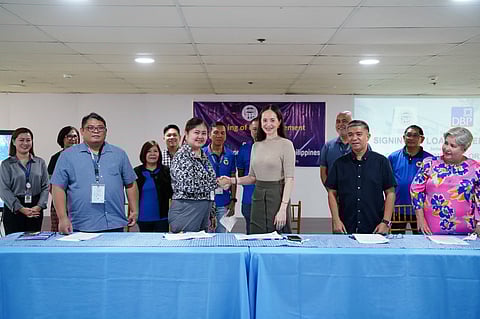 Ormoc City Mayor Lucy Marie Torres-Gomez (center) shakes hands with DBP Tacloban Lending Center head Janet Dacillo for the signing of the loan agreement.