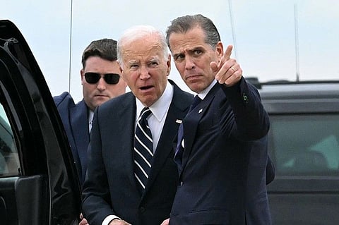 US President Joe Biden talks with his son Hunter Biden upon arrival at Delaware Air National Guard Base in New Castle, Delaware, on June 11, 2024, as he travels to Wilmington, Delaware.