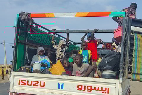 People displaced from Sudan's Jazira state arrive in packed vehicles to the entrance of the eastern city of Gedaref on June 10, 2024, amid the ongoing conflict between the Sudanese army and the paramilitary Rapid Support Forces (RSF).