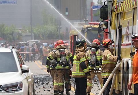 Firefighters work to extinguish a fire at a lithium battery factory in Hwaseong after a major fire broke out at a South Korean lithium battery factory with one person confirmed dead and 21 others unaccounted for as the blaze continued to rage.