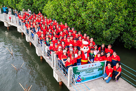JOLLIBEE employees, with Jollibee mascot, prepare to plant mangrove seedlings at the Bued Mangrove Ecopark in Alaminos, Pangasinan last month.