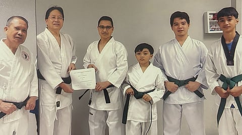 SIKAP president Manny Inserto (second from left) awards the Certificate of Promotion as 1st Dan Black Belt to Terry Villoria (third from left) during the belting ceremony at the Comchest Center. Also shown are SIKAP assistant vice president for Luzon Tony Dacalos (left) and newly-promoted green belters in Francis Nathan Tajanlangit, Lloyd Tristan Celemin and Marco Jake de Asis.