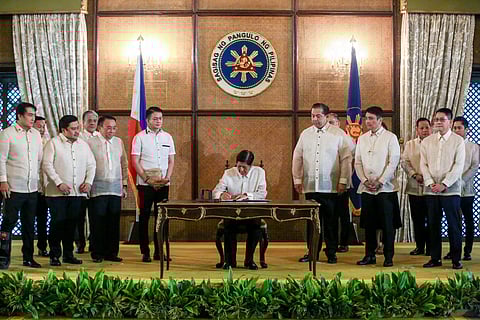 (FILES) President Marcos signing a measure into law