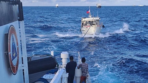 (FILES) A Philippine Coast Guard vessel tows back to port the ML Kalayaan, one of several vessels chartered to bring supplies to Filipino soldiers aboard the BRP Sierra Madre, after it suffered engine trouble from a water cannon attack Sunday by a Chinese Coast Guard ship. Another Philippine boat was also ‘rammed’ by the Chinese.