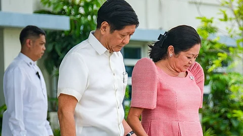 (FILES) President Ferdinand Romualdez Marcos Jr. and First Lady Liza Araneta-Marcos hold hands as they depart for a three-day state visit to Malaysia via PR-001 on Maharlika, Villamor Airbase, Pasay City.